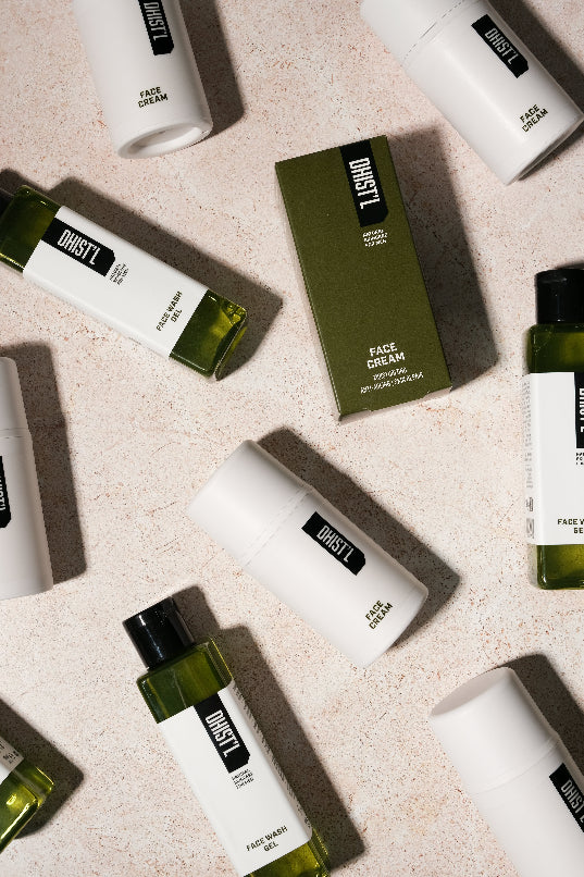 Various skincare products with 'DUST' branding on a beige surface